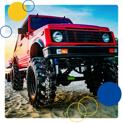 Red off-road truck parked on sand
